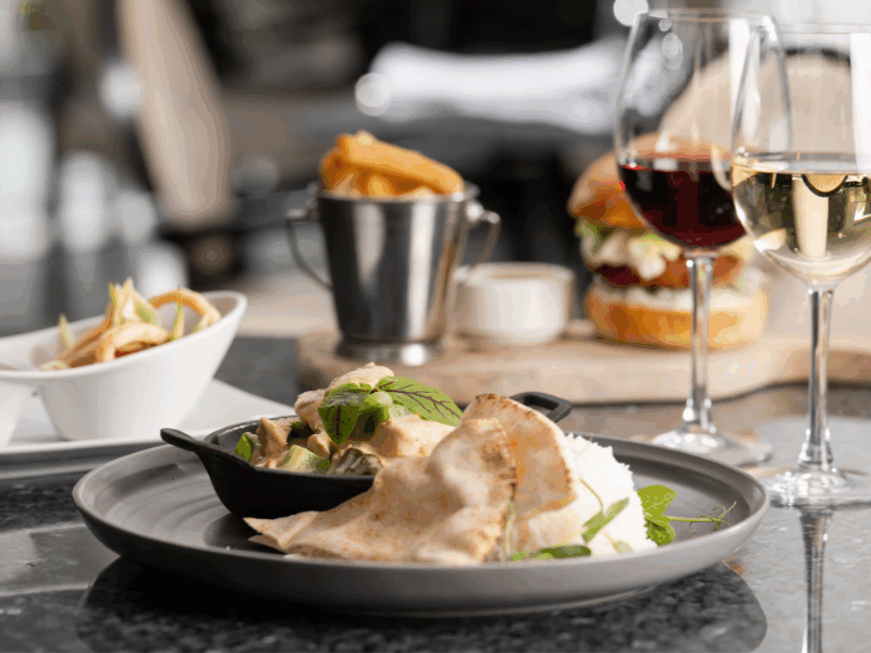 Indulge in gourmet dishes on elegantly set tables, featuring exquisite wine, at our hotel's fine dining restaurant.