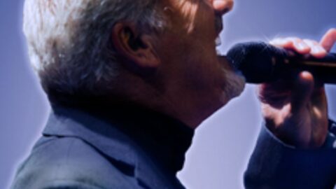 for the atmosphere and experience. 

ALT_TEXT: Elegant performer sings passionately on stage, enhancing the vibrant nightlife experience at the hotel.